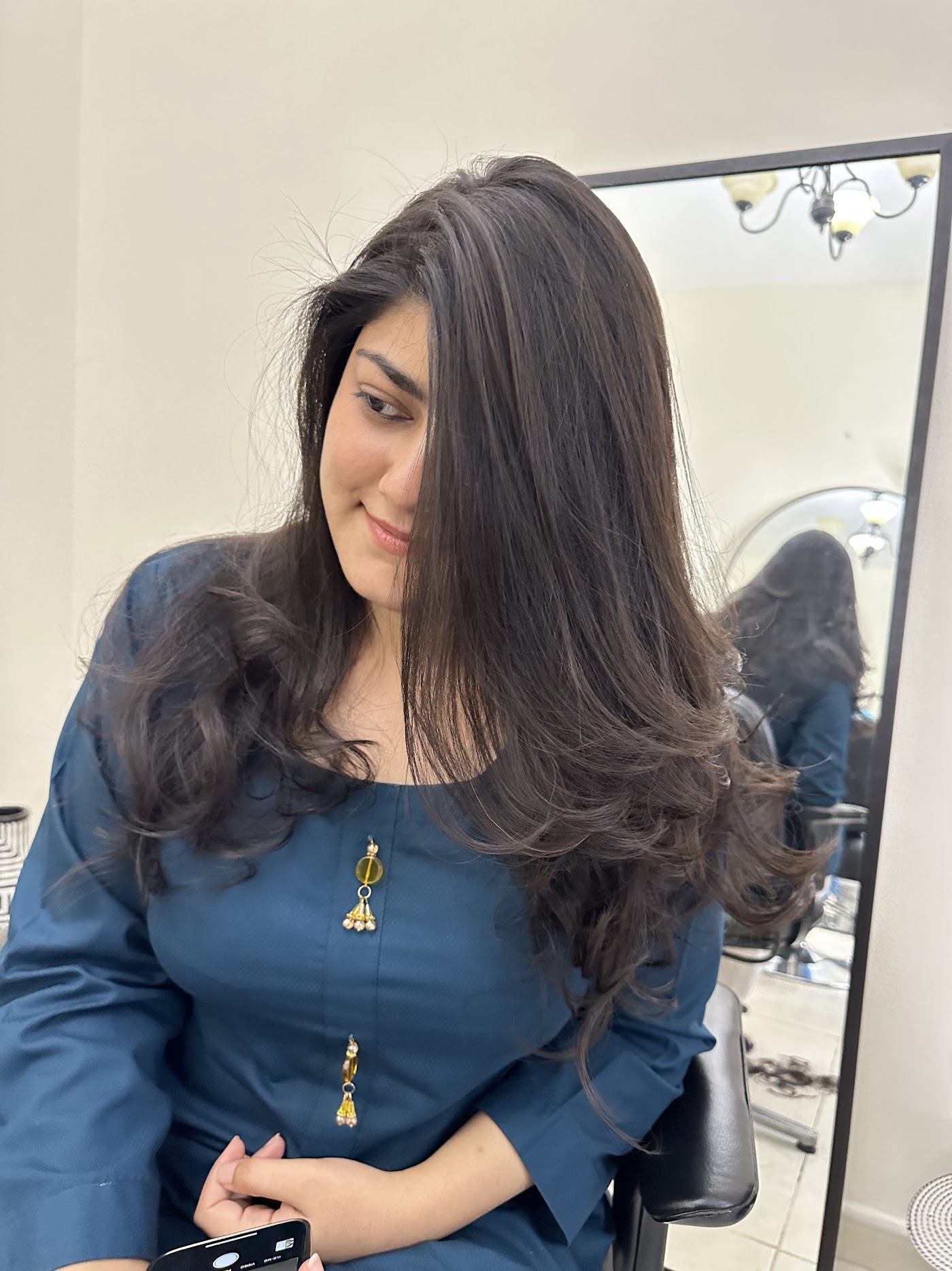 Client with long layered dark hair in the studio
